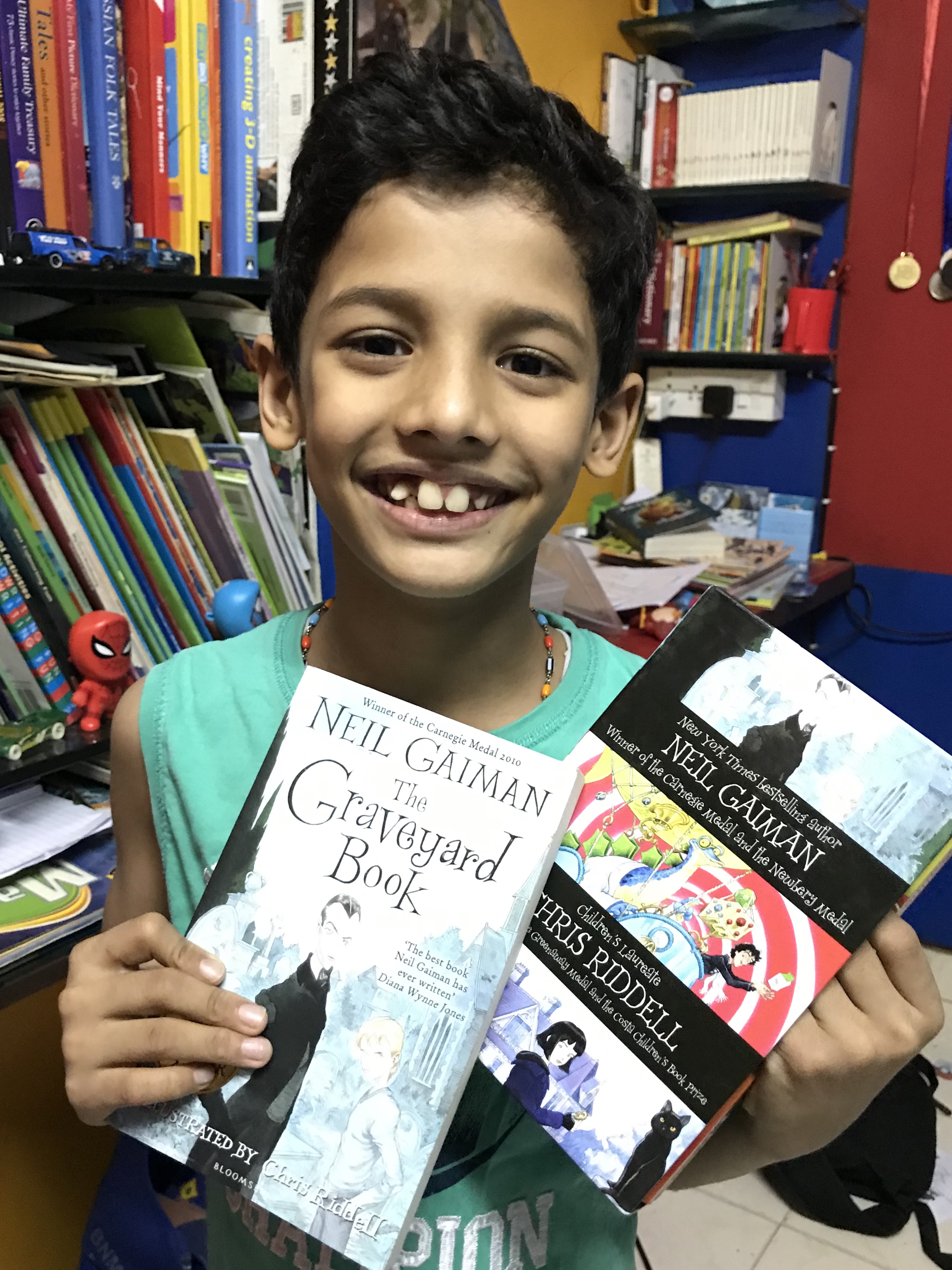Inesh Shenoy of #iThree and Co poses with the box set of three Neil Gaiman books